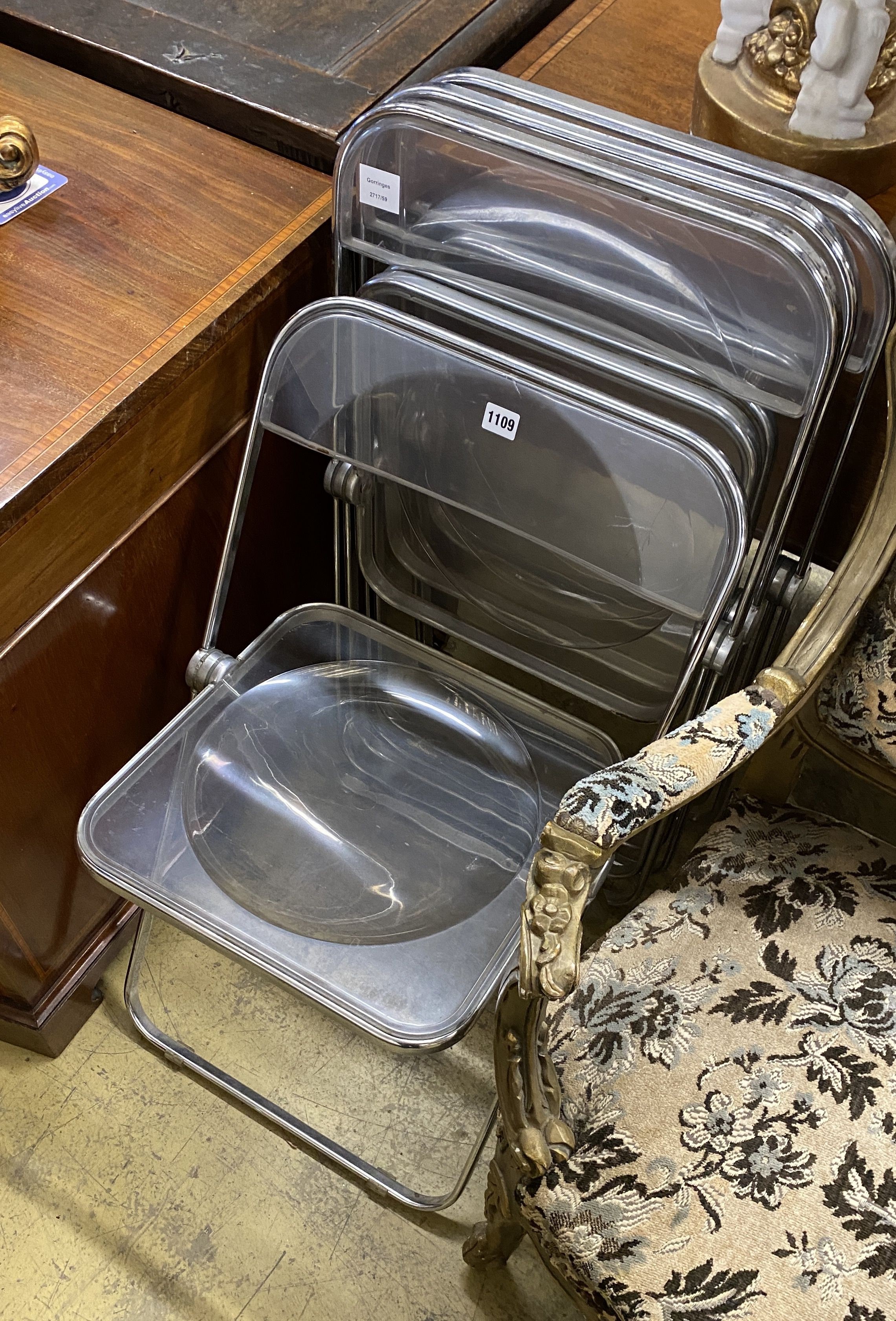 A set of four mid century chrome and perspex folding chairs